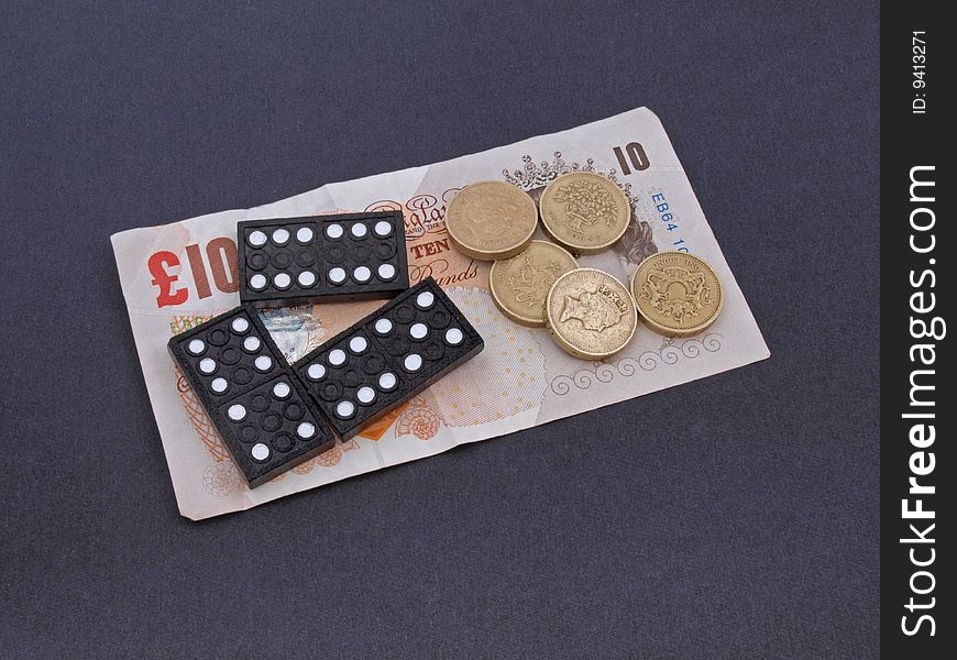 Concept of gambling showing coins, notes and dominos. Concept of gambling showing coins, notes and dominos.