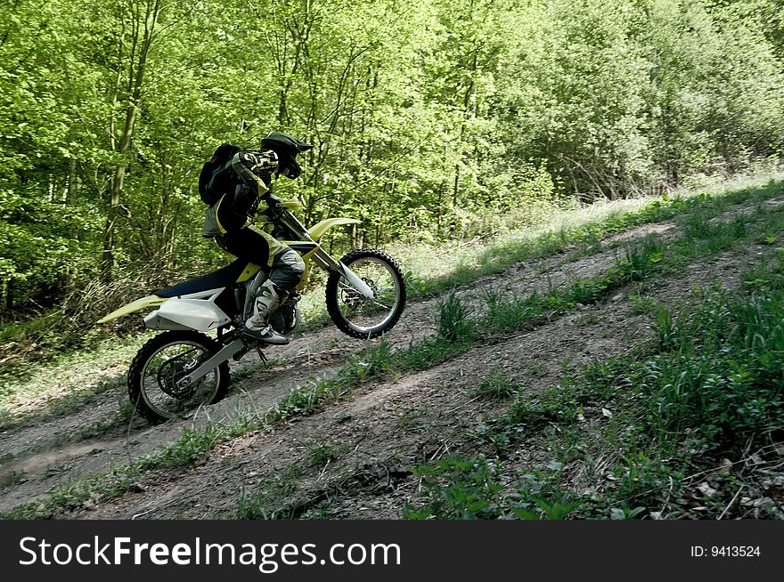 An enduro rider fast moving on motocross.