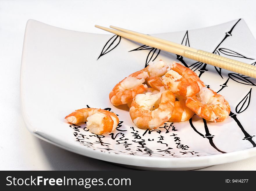 Shrimp and chopsticks on plate