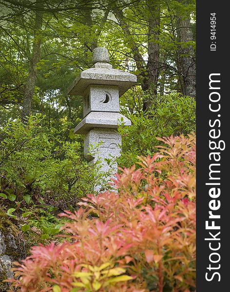 Granite japanese lantern in the middle of forest setting. Granite japanese lantern in the middle of forest setting
