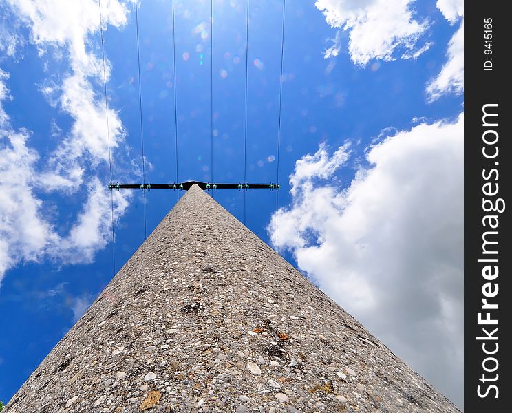 A shot of a power pole against a blue spring sky