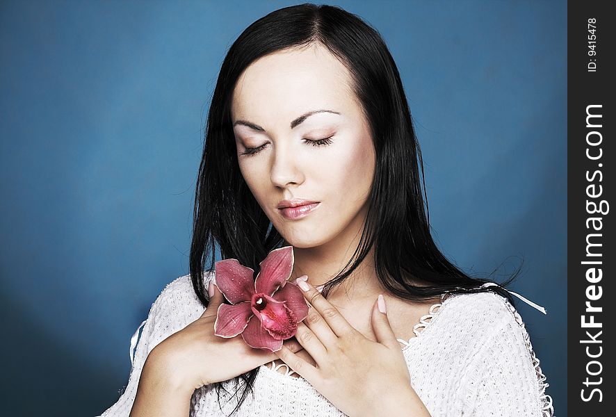 Portrait of young woman with  pink orchid. Portrait of young woman with  pink orchid