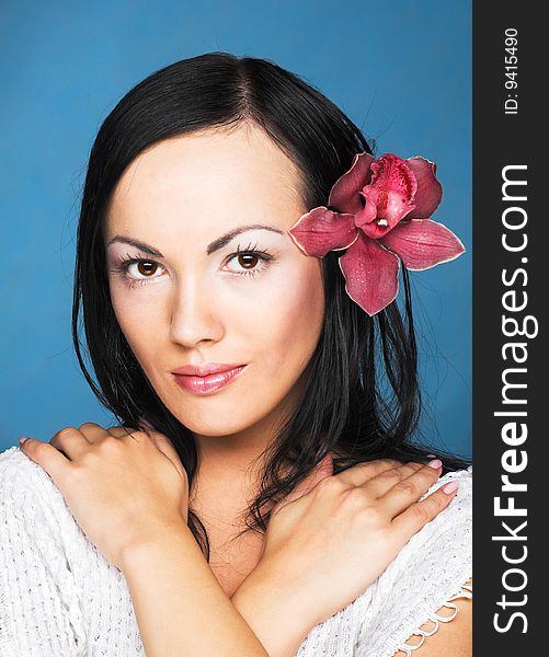 Portrait of young woman with  pink orchid. Portrait of young woman with  pink orchid