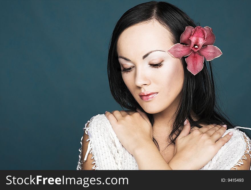 Portrait of young woman with pink orchid. Portrait of young woman with pink orchid