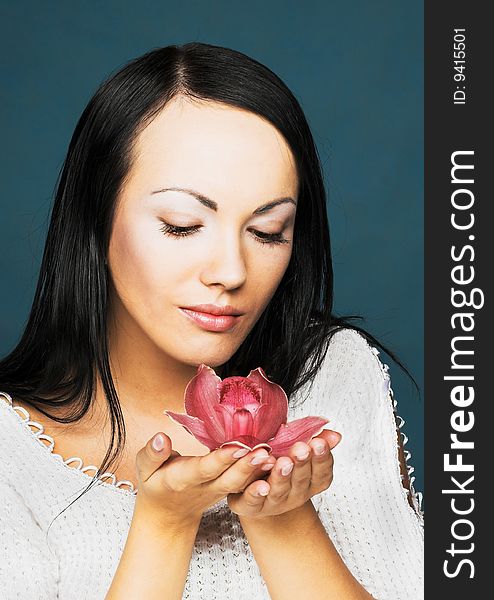 Portrait of young woman with pink orchid. Portrait of young woman with pink orchid