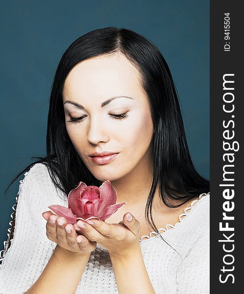Portrait of young woman with pink orchid. Portrait of young woman with pink orchid