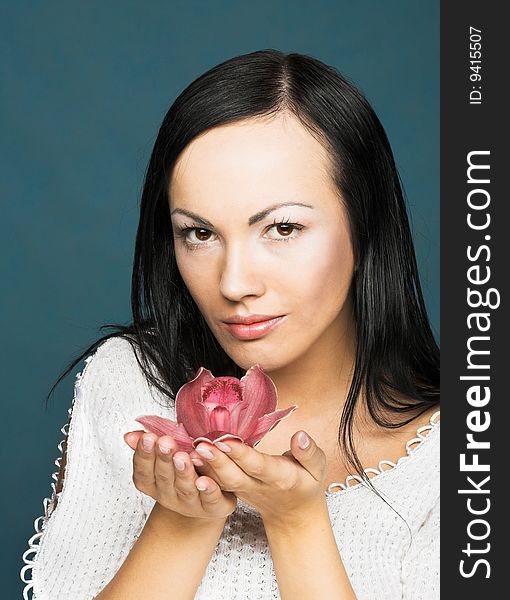 Portrait of young woman with  pink orchid. Portrait of young woman with  pink orchid