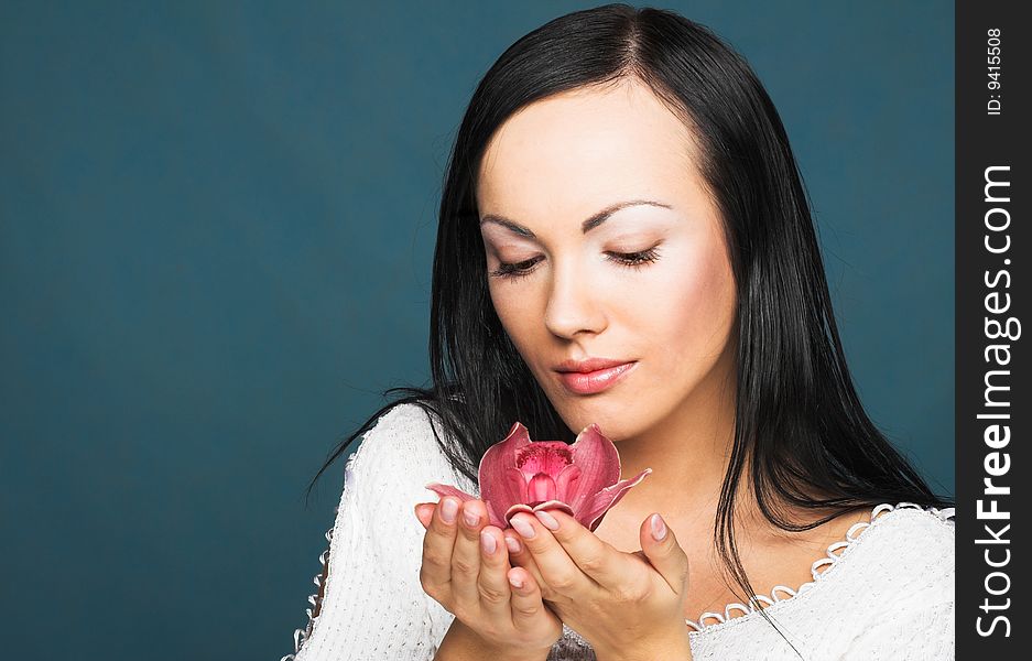 Portrait of young woman with  pink orchid. Portrait of young woman with  pink orchid