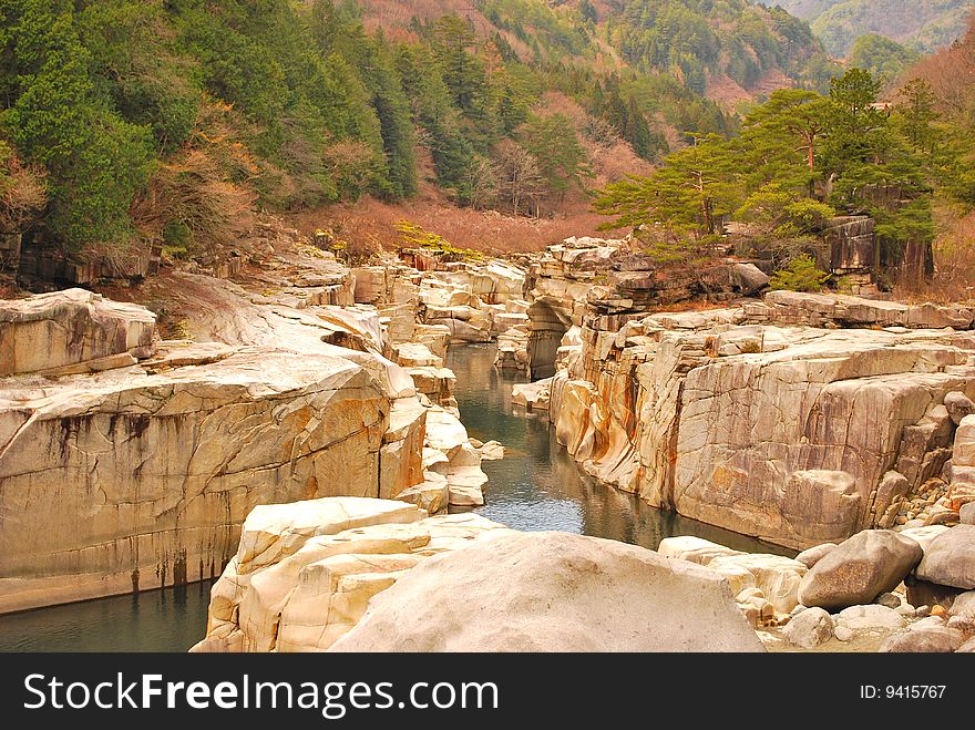 A low view of a majestic ravine formed naturally at a mountain valley. A low view of a majestic ravine formed naturally at a mountain valley