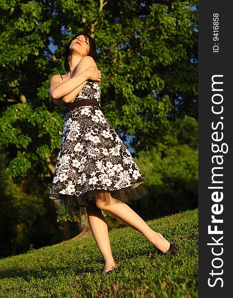 Happy looking young woman wearing a floral print dress