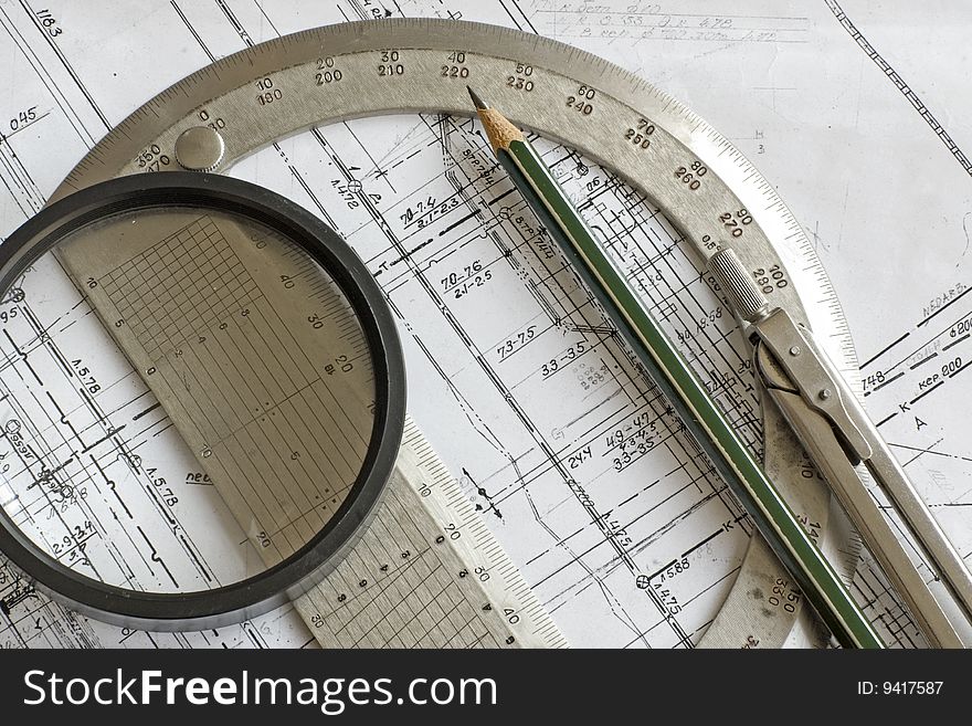 Engineering blueprint with pencil, steel protractor, compass and loupe. Engineering blueprint with pencil, steel protractor, compass and loupe