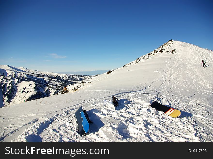 Three snowboards on the snow, ready to ride