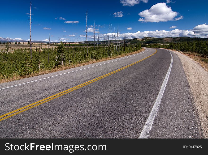 Empty highway with blue sky and clouds