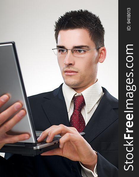 Young business man working on a laptop close up