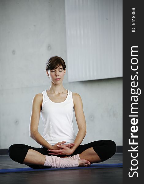 Young maid concentrat in yoga sit. Young maid concentrat in yoga sit