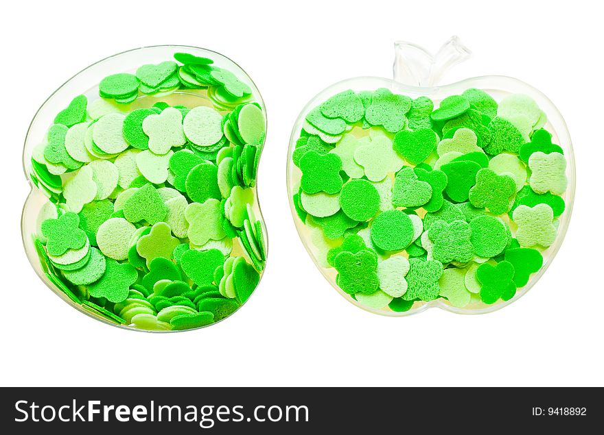 Geometrical figures of different shades of green poured into transparent containers in the form of apple