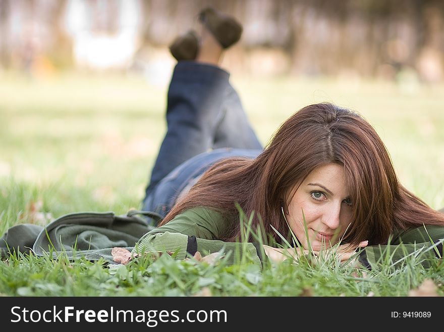 Young woman on grass, daydreaming. Young woman on grass, daydreaming