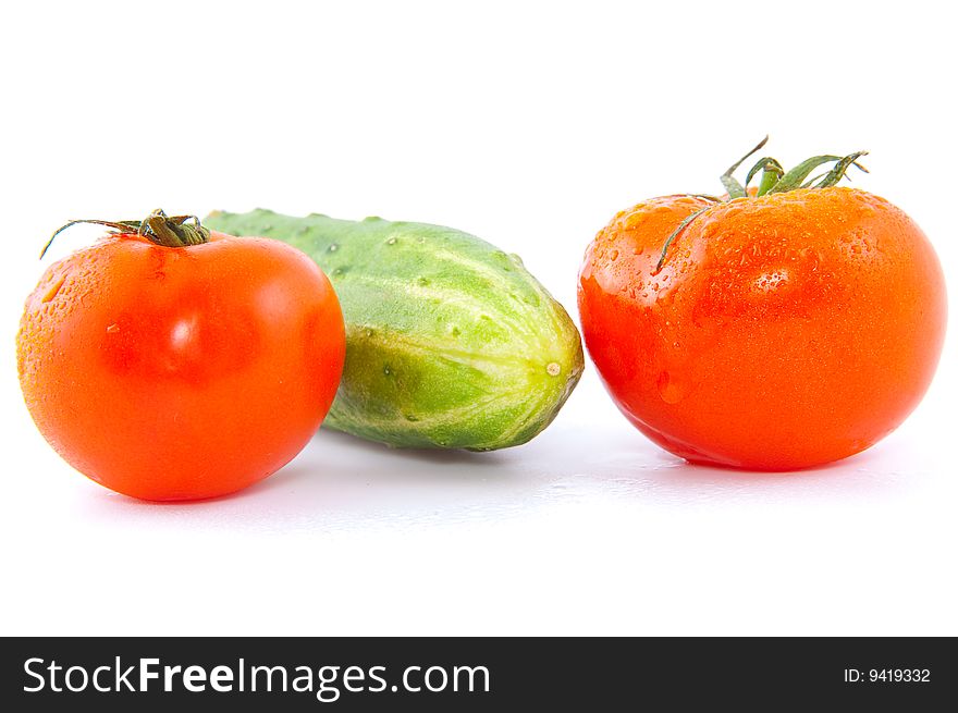 Red fresh tomatoes with cucumber isolated on white