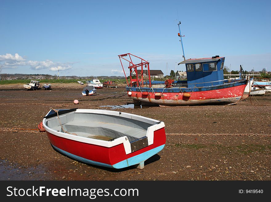 Fishing boat and tender at low tide