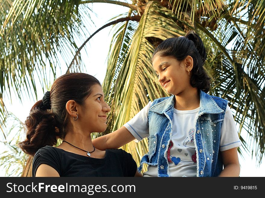 A young teenage Indian girl and her little sister having a great time. A young teenage Indian girl and her little sister having a great time.