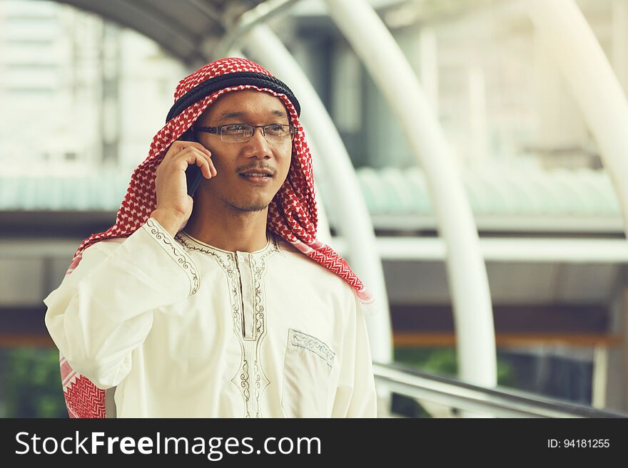 Arab Businessman Messaging On A Mobile Phone In The City