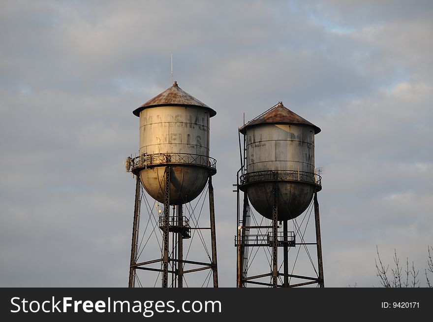 Water towers with faded signs in late afternoon light. Water towers with faded signs in late afternoon light.