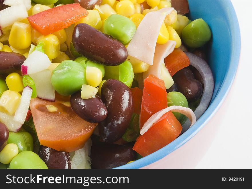 Fresh garden salad in a colorful bowl isolated on white background. Fresh garden salad in a colorful bowl isolated on white background