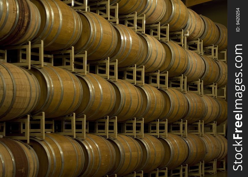 Wine barrels on racks in storage. Wine barrels on racks in storage