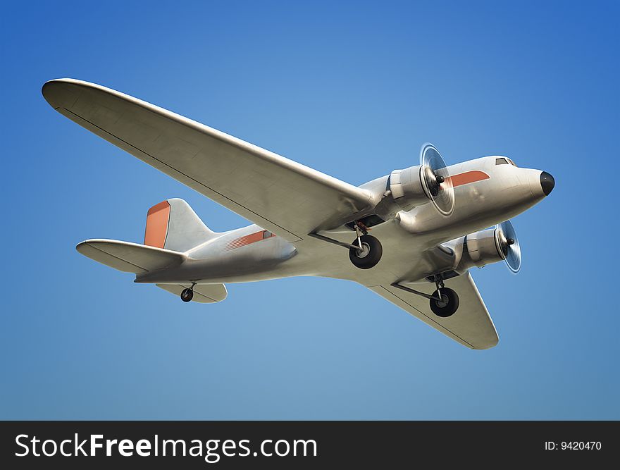 A Shot of a DC3 airplane in flight against a blue sky. A Shot of a DC3 airplane in flight against a blue sky