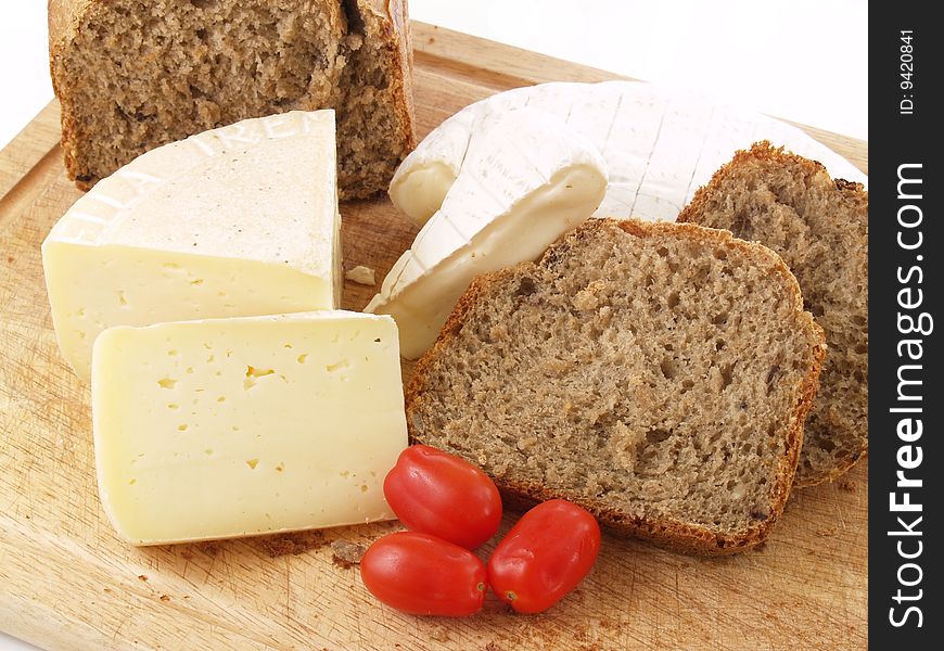Bread, tomatoes and different cheeses on a white background. Bread, tomatoes and different cheeses on a white background
