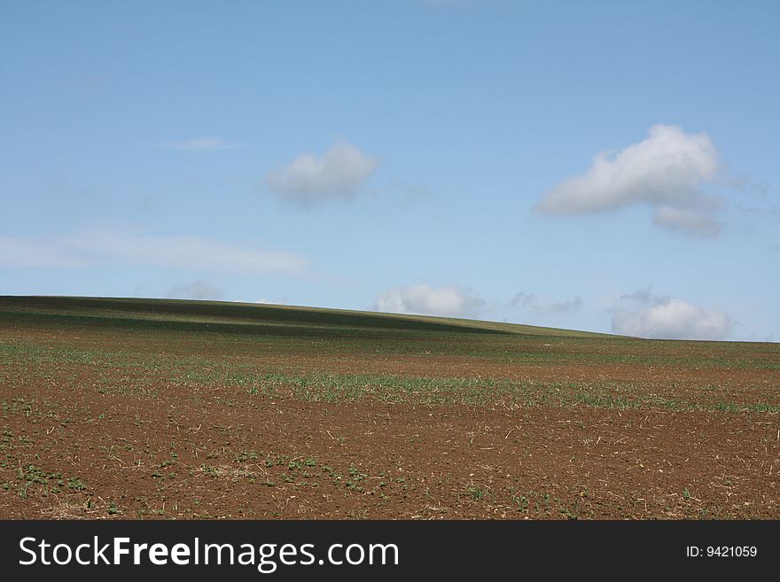 Vast rural field with clouds. Vast rural field with clouds