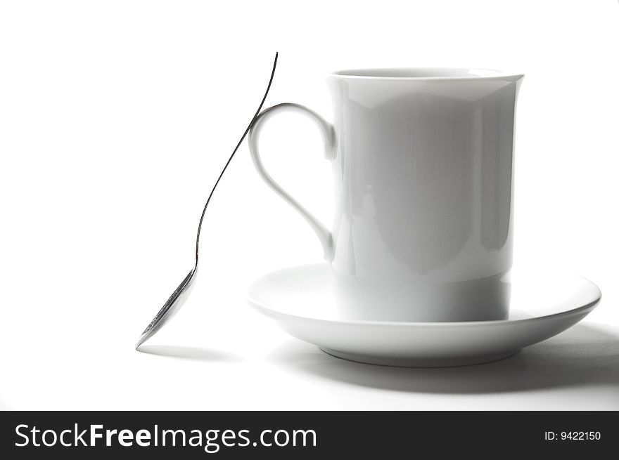 Isolated close-up cup of tea and rhe spoon. Isolated close-up cup of tea and rhe spoon