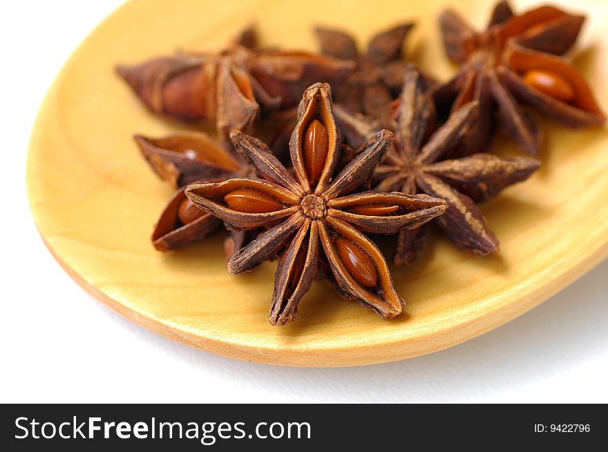 Star anise on wooden scoop