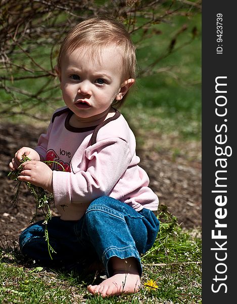 Baby girl playing in the backyard. Baby girl playing in the backyard