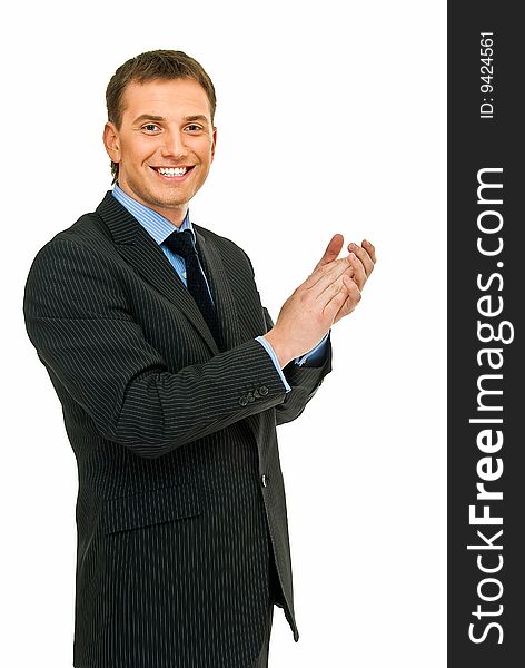 Young handsome businessman claps one`s hands on white. Young handsome businessman claps one`s hands on white