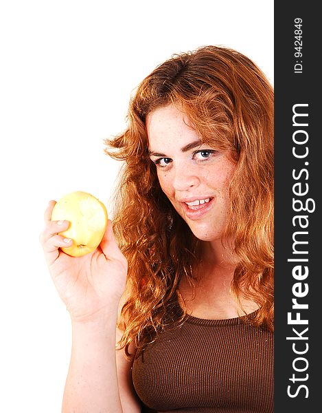 Pretty long red haired girl shows her yellow apple what she just started eating. Pretty long red haired girl shows her yellow apple what she just started eating.