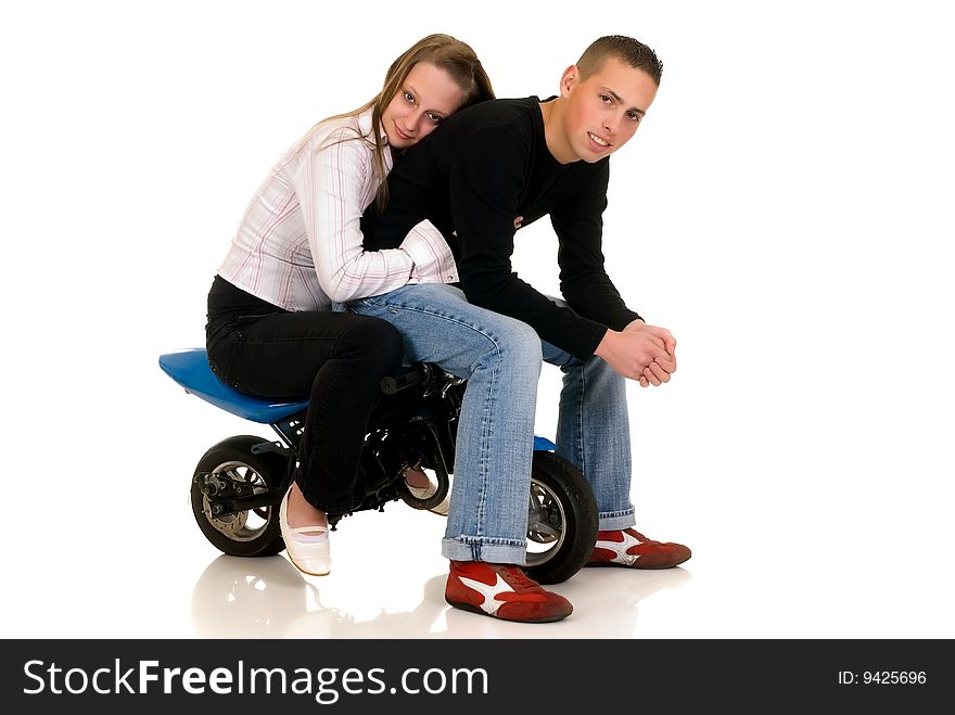 Youngsters show off with their pocket-bike, studio shot on white background. Youngsters show off with their pocket-bike, studio shot on white background