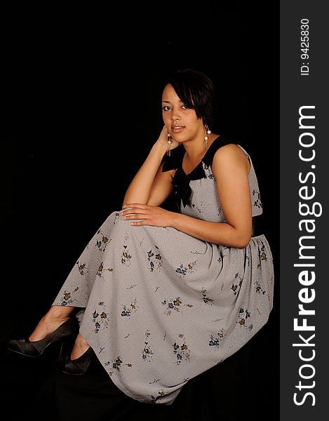 A closeup portrait of a pretty African American teenage woman. Black background. A closeup portrait of a pretty African American teenage woman. Black background