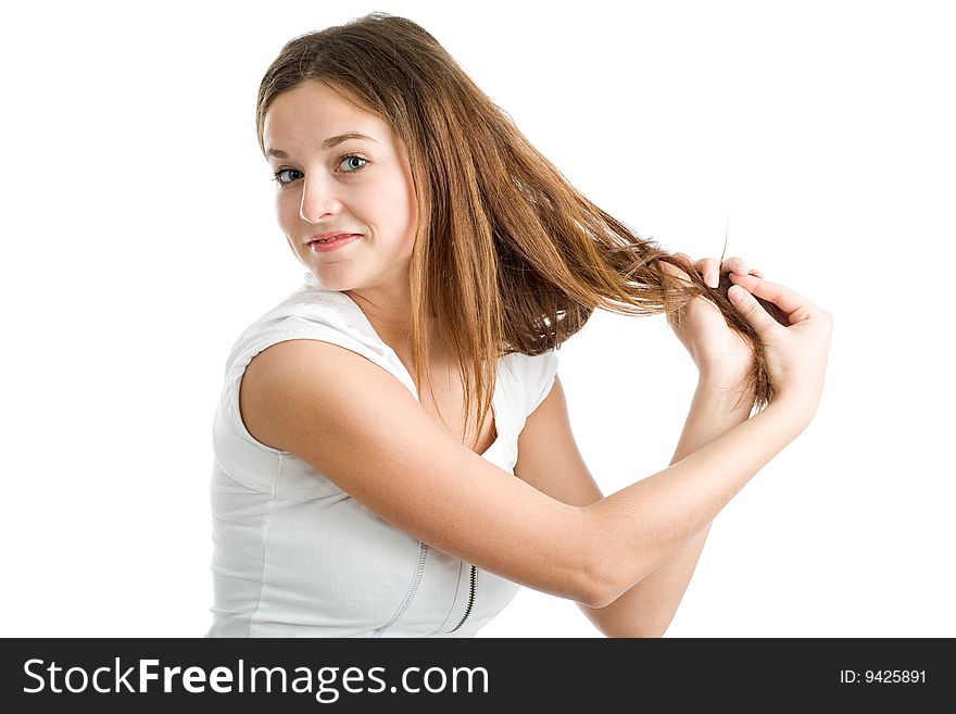 A beautiful young smiling woman with long brown hair posing on a white background