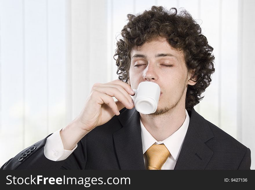 Businessman taking a break with a cup of coffee in the office