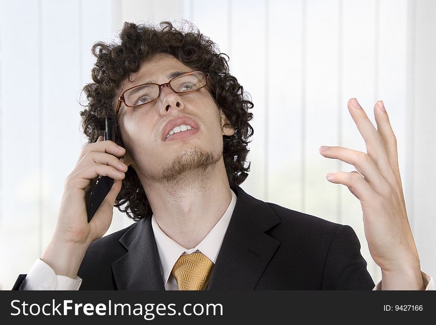 Business man with mobile phone in the office