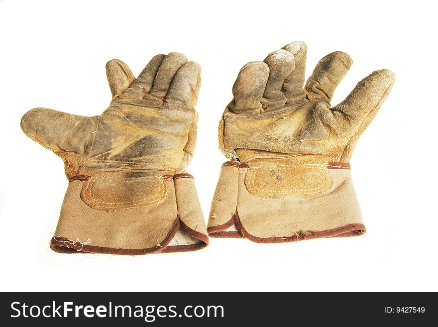 Pair of well worn riggers gloves isolated on white. Pair of well worn riggers gloves isolated on white