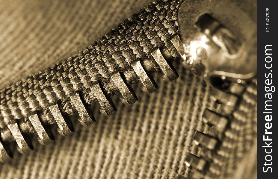 Closeup or macro of an open brown zipper. Closeup or macro of an open brown zipper
