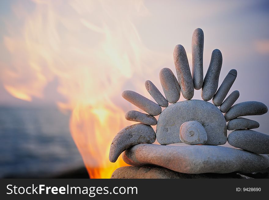 Symbol of Sun from the gravel in flames. Symbol of Sun from the gravel in flames