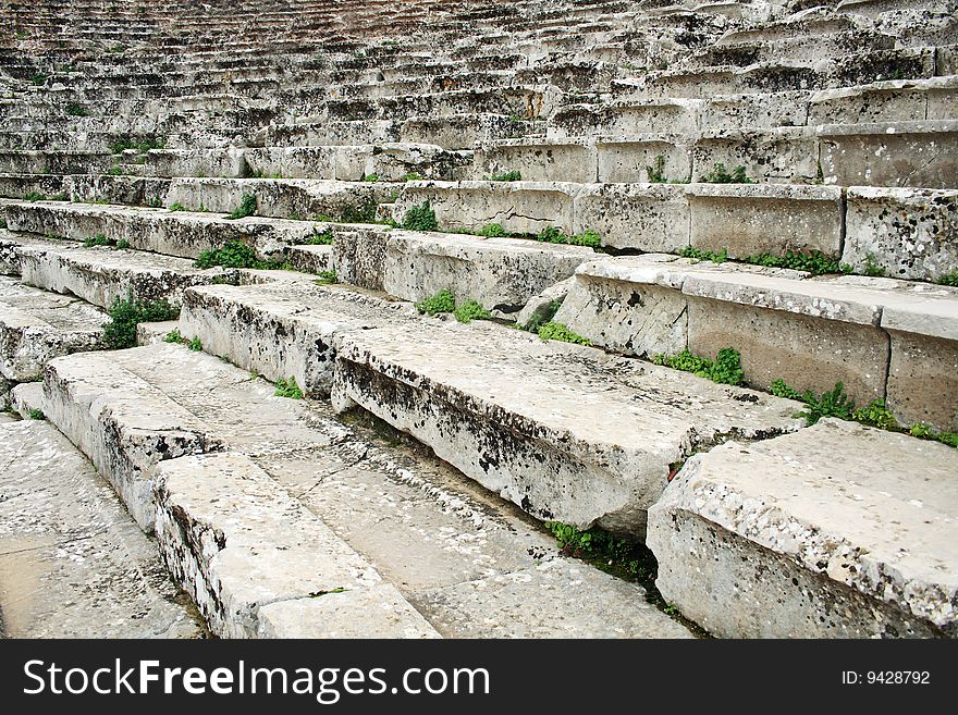 Close-up of ancient Greek amphitheatre stairs, background