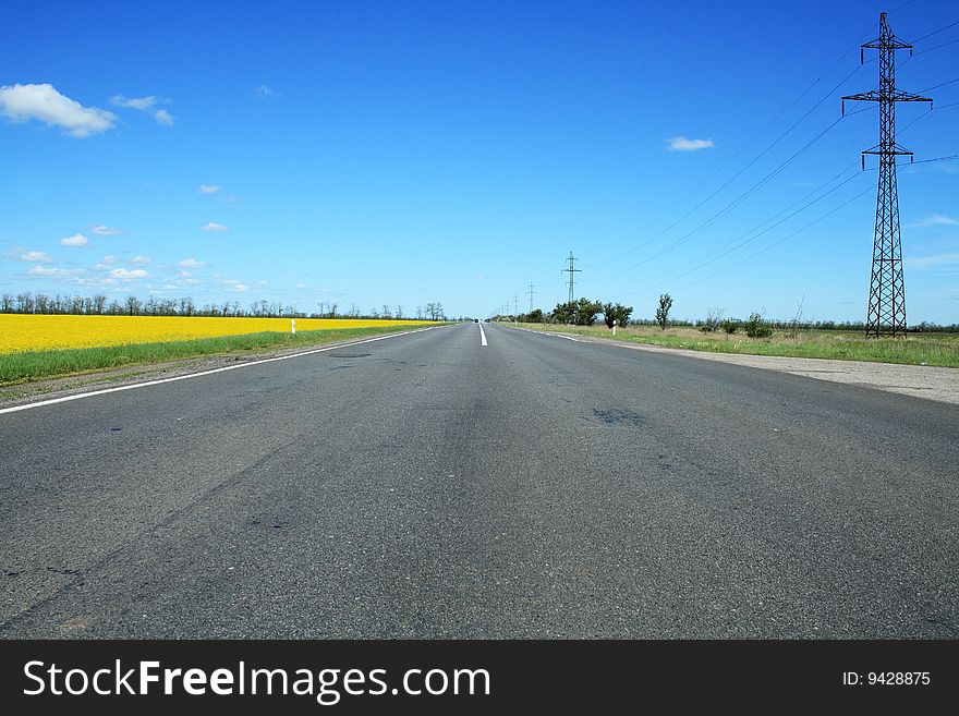 Summer landscape with deserted highway under blue sky. Summer landscape with deserted highway under blue sky