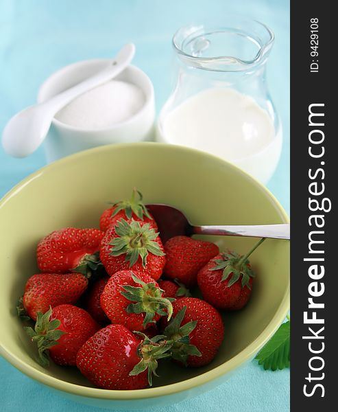 Strawberries in bowl, jug of milk or yoghurt and sugar. Strawberries in bowl, jug of milk or yoghurt and sugar.