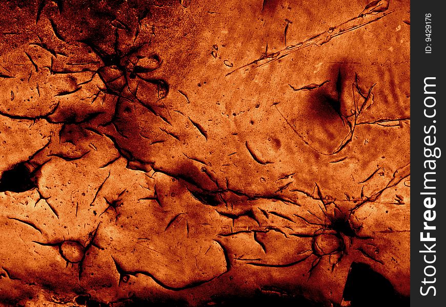 Grunge cracked paint - deep black cracks in thick orange paint