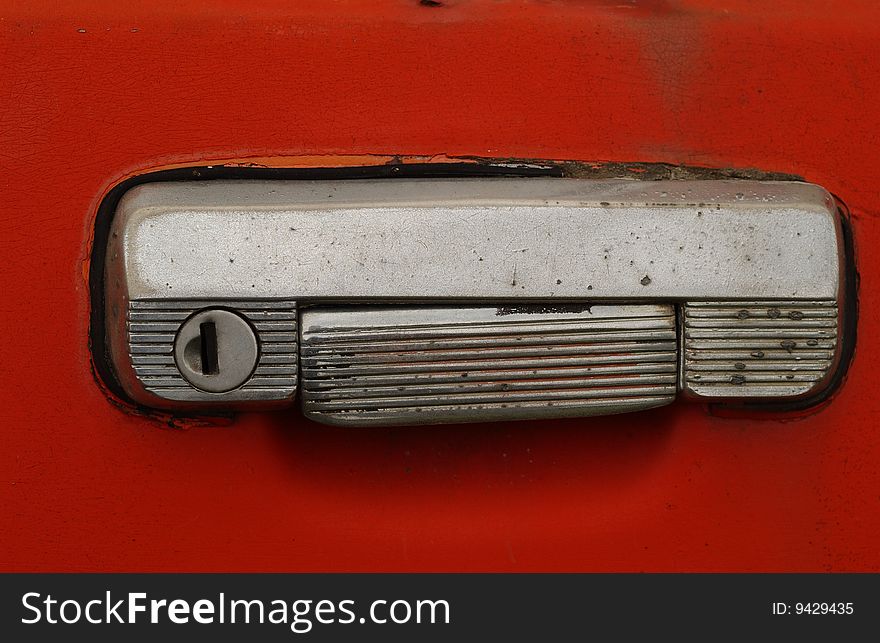 An old lock on the old orange car. An old lock on the old orange car