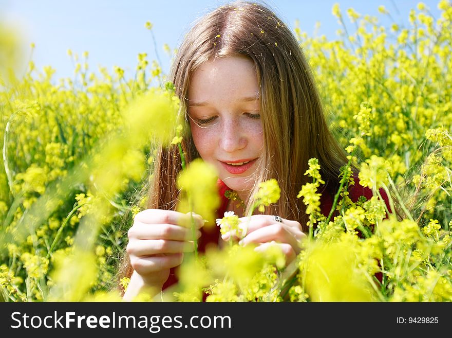 Young girl with long hair in yellow flowers